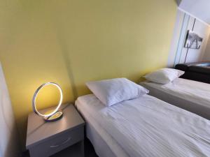 a room with two beds and a mirror on a table at Hotel Jabłoński in Dorotowo +19 photos