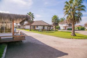 a bench in front of a house with palm trees at Cabañas Las Añañucas I in La Serena