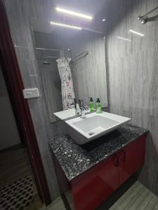 a bathroom with a white sink and a mirror at Samayra's Apartment in Nadi +17 photos