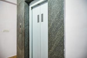 a sliding glass door in a room at Hotel O Shraddha Residency 2 in Pānchuria