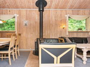 a living room with a wood stove in a room at 6 person holiday home in Silkeborg in Silkeborg +11 photos