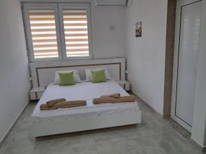 a bedroom with a bed with two towels on it at Apartments BIA in Gevgelija