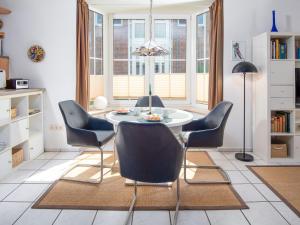 a dining room with a table and chairs at Holiday Home Richtpfad by Interhome in Norden
