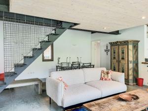 a living room with a couch and a staircase at Apartment Cantagallo by Interhome in Vernate