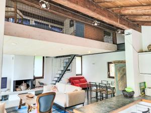 an open living room with a loft at Apartment Cantagallo by Interhome in Vernate +13 photos
