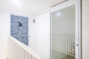 a staircase with a sliding glass door in a room at David Houses Nusa Dua Beach Bali RedPartner in Nusa Dua +25 photos