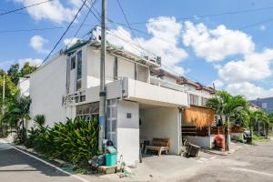 a white house on the side of a street at David Houses Nusa Dua Beach Bali RedPartner in Nusa Dua