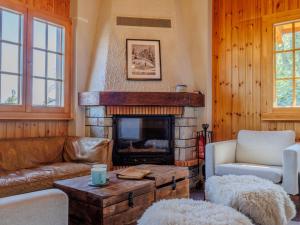 a living room with a couch and a fireplace at Chalet Chalet Soleil by Interhome in Nendaz