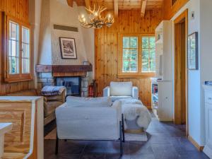 a living room with two chairs and a fireplace at Chalet Chalet Soleil by Interhome in Nendaz
