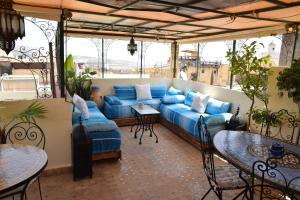 a living room with a blue couch on a balcony at Dar Omar in Fez