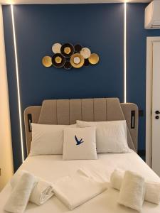 a bed with three donuts on a blue wall at Hera Elegant Suite by Zeus Suites in Athens