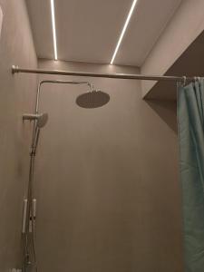 a shower in a bathroom with a shower curtain at Hera Elegant Suite by Zeus Suites in Athens +1 photo