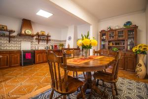 a large kitchen with a wooden table and chairs at Quinta Ti Lita in Tocha