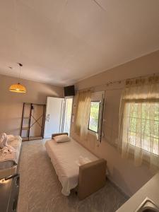 a bedroom with two beds and a window at Sykia Itamos Studio-2 in Sykia Chalkidikis