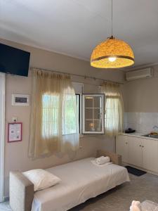 a bedroom with a large bed and a window at Sykia Itamos Studio-2 in Sykia Chalkidikis