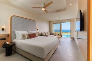a bedroom with a bed and a view of the ocean at Enorme Santanna Island - Premium All Inclusive in Sisi
