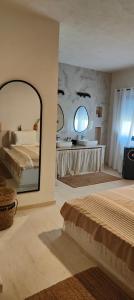 une chambre avec un lit et un grand miroir dans l'établissement Villa Nour Kélibia, à Kelibia 35 autres photos