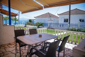 a table and chairs on the patio of a house at Tropical Beach "Orion" in Petalidi