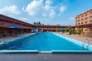a large swimming pool in front of a building at Hotel Triangle Mbarara in Mbarara