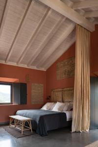 ein Schlafzimmer mit orangefarbenen Wänden und einem großen Bett in der Unterkunft Vale Palheiro Earth Resort - Soft Opening in Aljezur