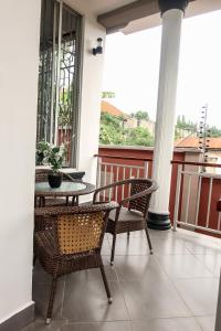 a patio with chairs and a table on a balcony at VanVei Villas and Apartments in Dar es Salaam
