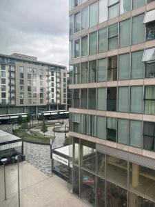 a large glass building with buildings in a city at Modern 1-Bedroom Apartment in The Hub, Milton Keynes - FREE PARKING in Milton Keynes