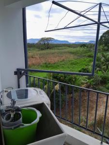 a balcony with a tub and a view of a field at Samayra's Apartment in Nadi