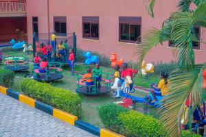 a group of children playing in a playground at Hotel Triangle Mbarara in Mbarara