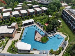 an aerial view of a resort with a swimming pool at Taj Damdama Lake Resort & Spa, Gurugram in Gurgaon