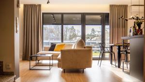 a living room with a couch and a table at Apartamenty Parkowa - Kamień Śląski in Kamień Śląski