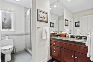 a white bathroom with a toilet and a sink at RMR: Teodori House in Teton Village in Teton Village +27 photos