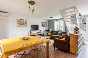 a living room with a yellow table and chairs at 5 bedroom house near Disneyland Paris in Serris