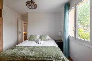 a bedroom with a large bed and a window at 5 bedroom house near Disneyland Paris in Serris
