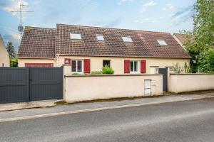 a house with a black fence and a house at 5 bedroom house near Disneyland Paris in Serris