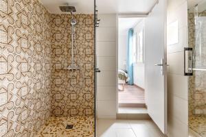 a bathroom with a shower with a glass door at 5 bedroom house near Disneyland Paris in Serris +24 photos