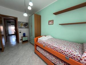 a bedroom with an orange bed in a room at Appartamento Gemma D'oro in Castellammare del Golfo