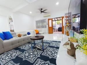 a living room with a couch and a table at Bukit Beruang 366D Family Home - Private Pool in Melaka