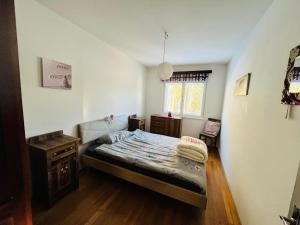 a small bedroom with a bed and a window at Casa Vacanze Natura in Mendola