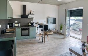 a kitchen with green appliances and a dining room at DUO Residences in Dunajská Streda