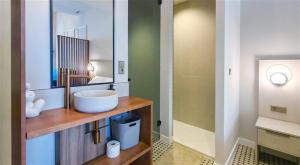 a bathroom with a sink and a mirror at Heritage apartamentos in Villajoyosa +98 photos