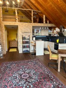 a kitchen with a table and a rug on the floor at Reiterhof vom Litzlbach in Langquaid