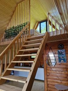 a wooden staircase in a house with wooden walls at Cozy Cottage A in Kutaisi +13 photos