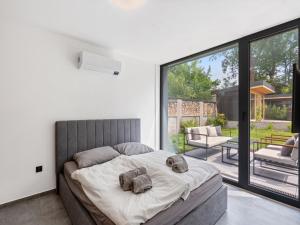 a bedroom with a bed with two stuffed animals on it at Holiday Home Romance & Relax Villa by Interhome 