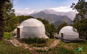 two domes on a hill with mountains in the background at Zostel Homes Billing - Bir in Biling +38 photos