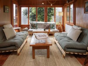 a living room with two couches and a coffee table at Chalet Quinette by Interhome in Ovronnaz