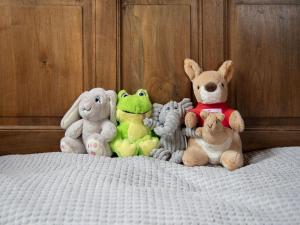 a group of stuffed animals sitting on a bed at Chalet Quinette by Interhome in Ovronnaz +22 photos