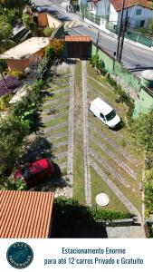 a white car parked on the side of a road at Casa das Tartarugas in Angra dos Reis