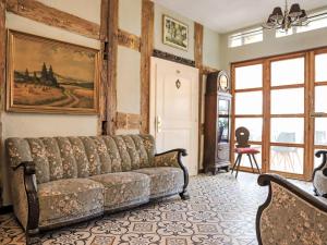 a living room with a couch and a table at Apartment King George III by Interhome in Mirow +27 photos