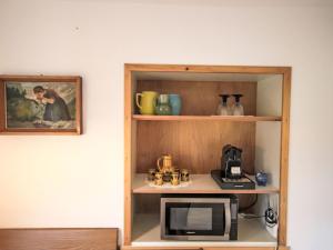 a shelf with a microwave in a room at Apartment Alpenfarm Poschhof by Interhome in Kaunerberg +44 photos