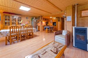 a living room with a kitchen and a dining room at Chalet La Tournette in Montmin